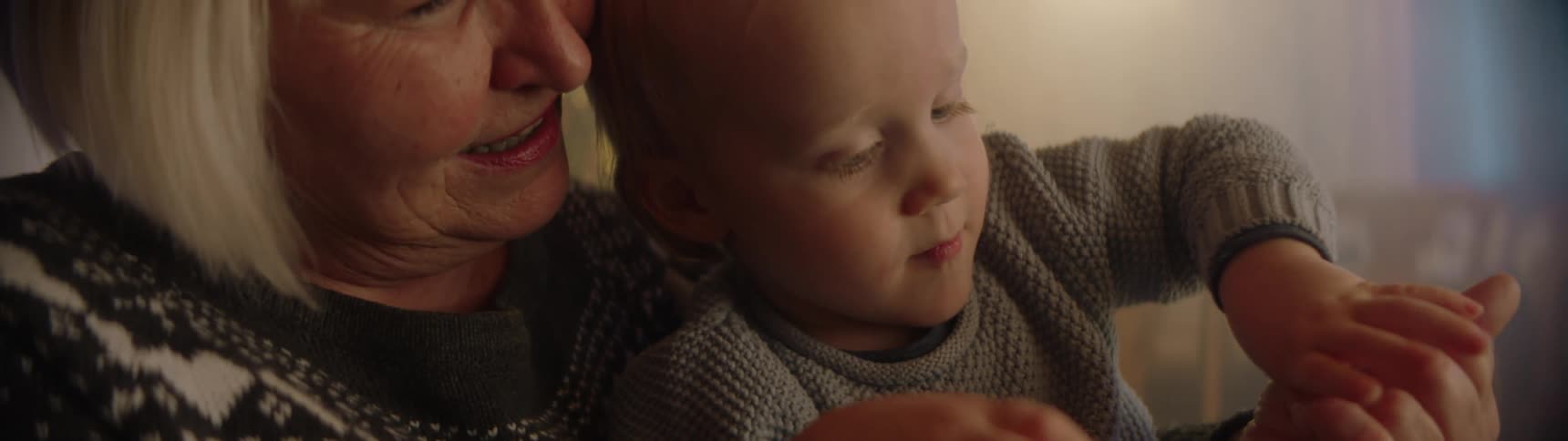 A boy sits in his grandmothers lap