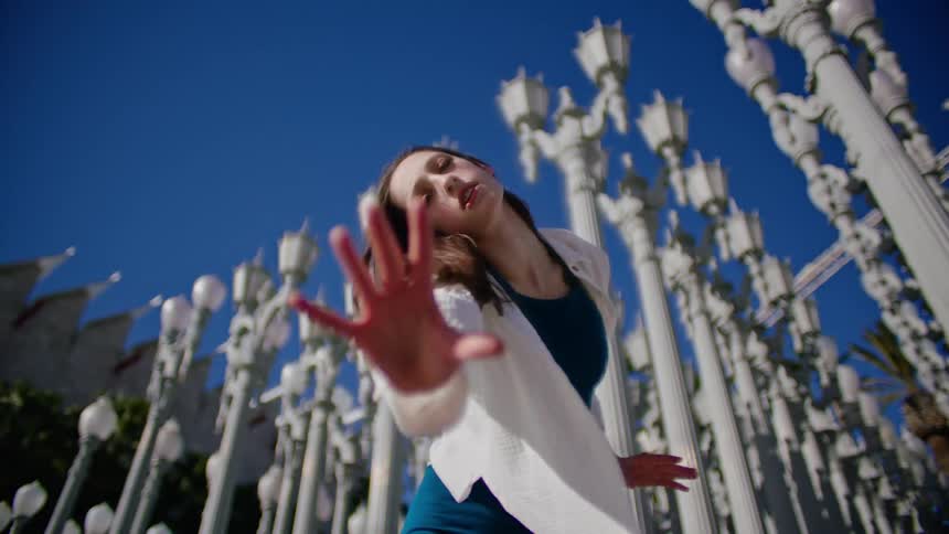 A woman is dancing outside
