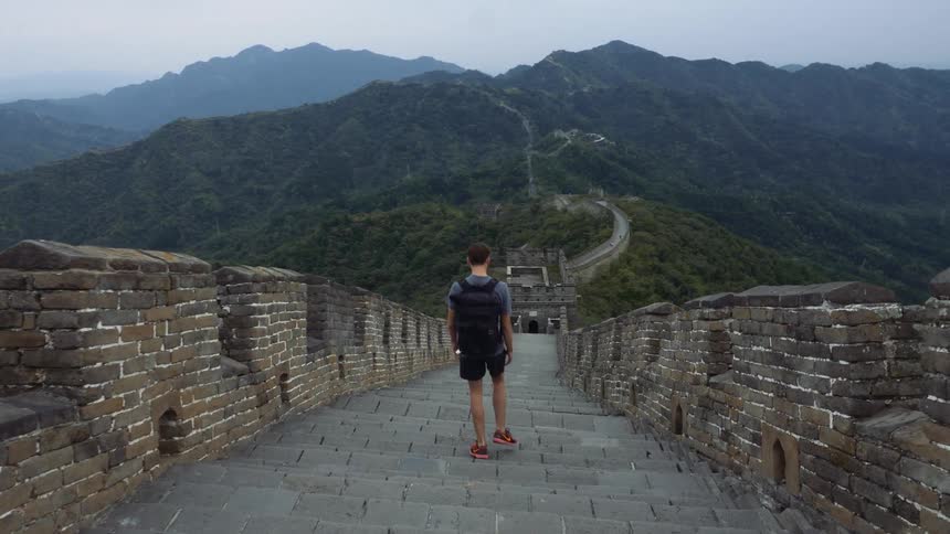 A man is hiking over the long wall