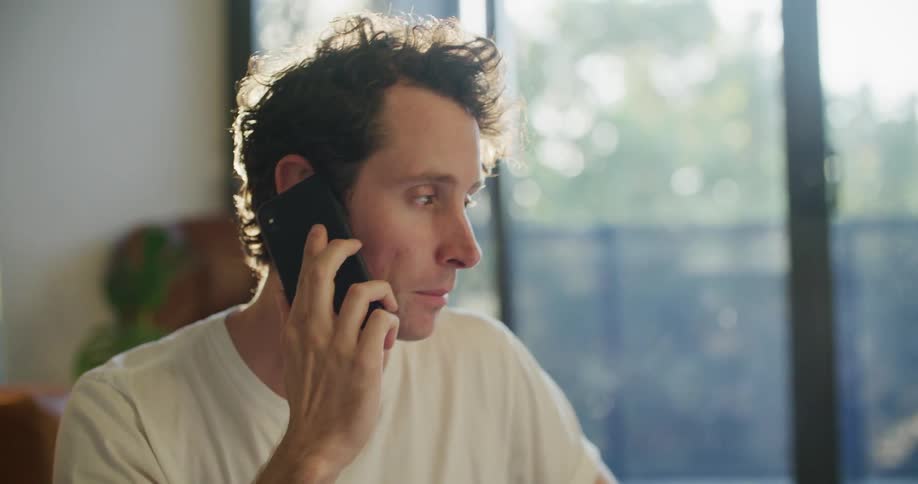 A man picks up his cell and starts talking