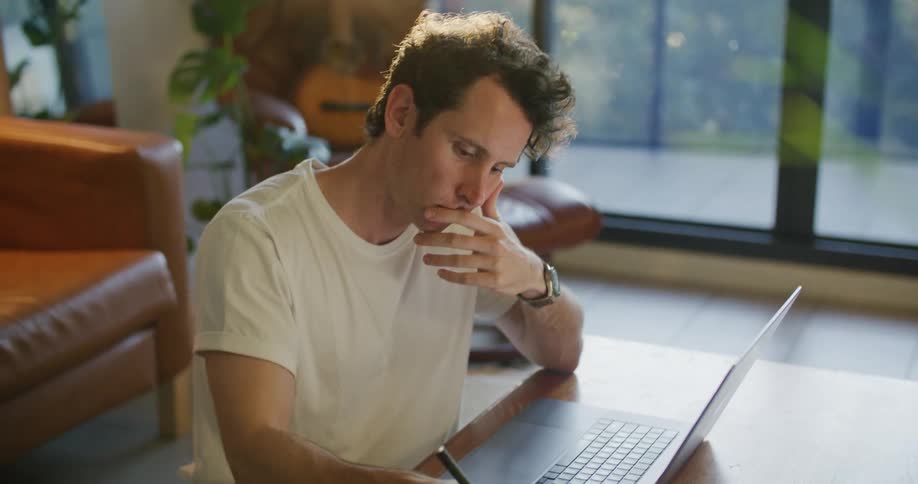 A man works from home on his laptop