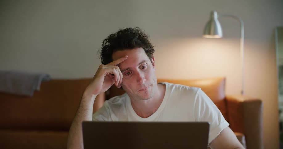 A man is looking at his laptop