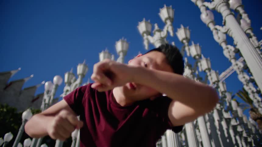 A man is dancing on a sunny day