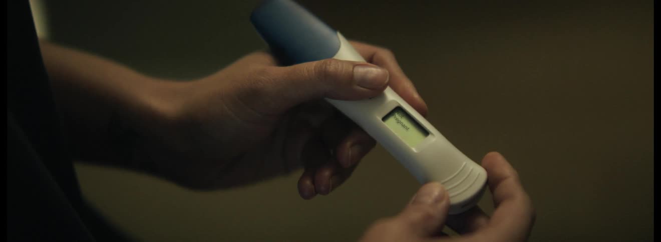 Woman hand holding a pregnancy test