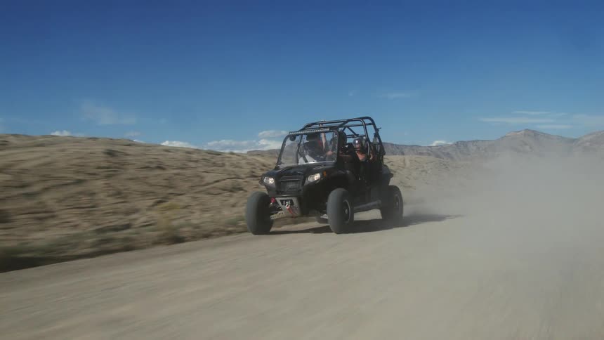 Atv with a mad face off roading on dirt trail in the desert