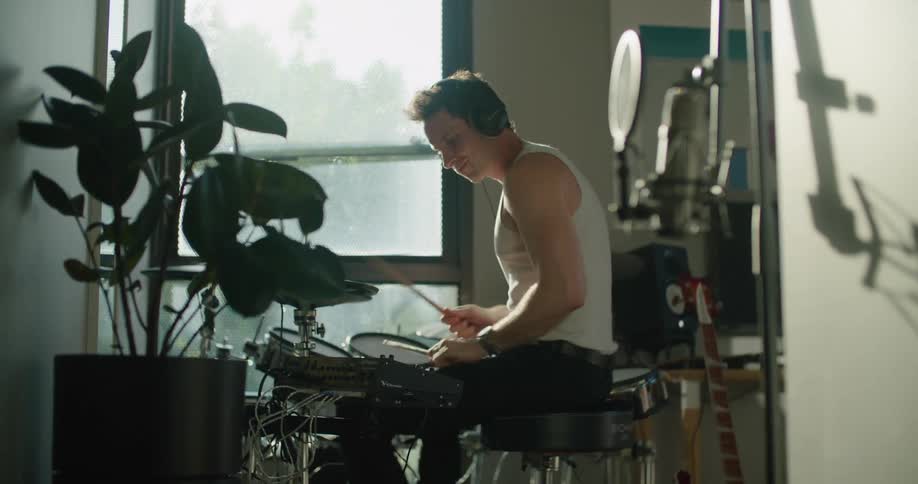 A man playing drums in a room