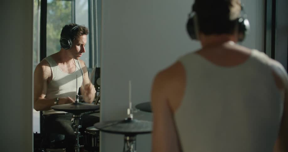 A man at home plays the drums