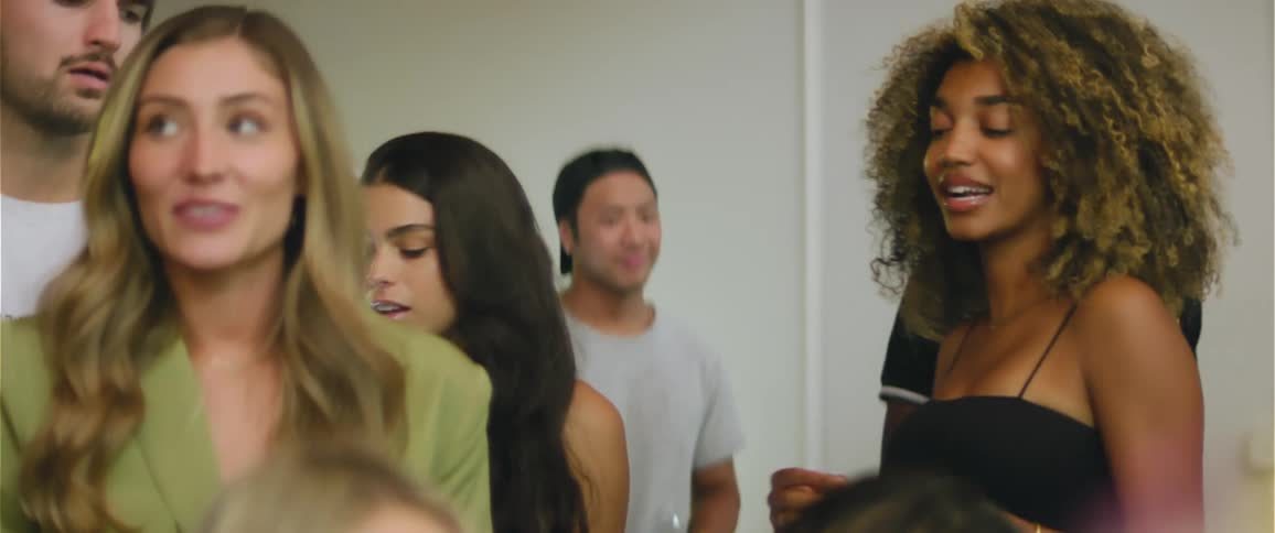 Happy group of friends dancing together on a party