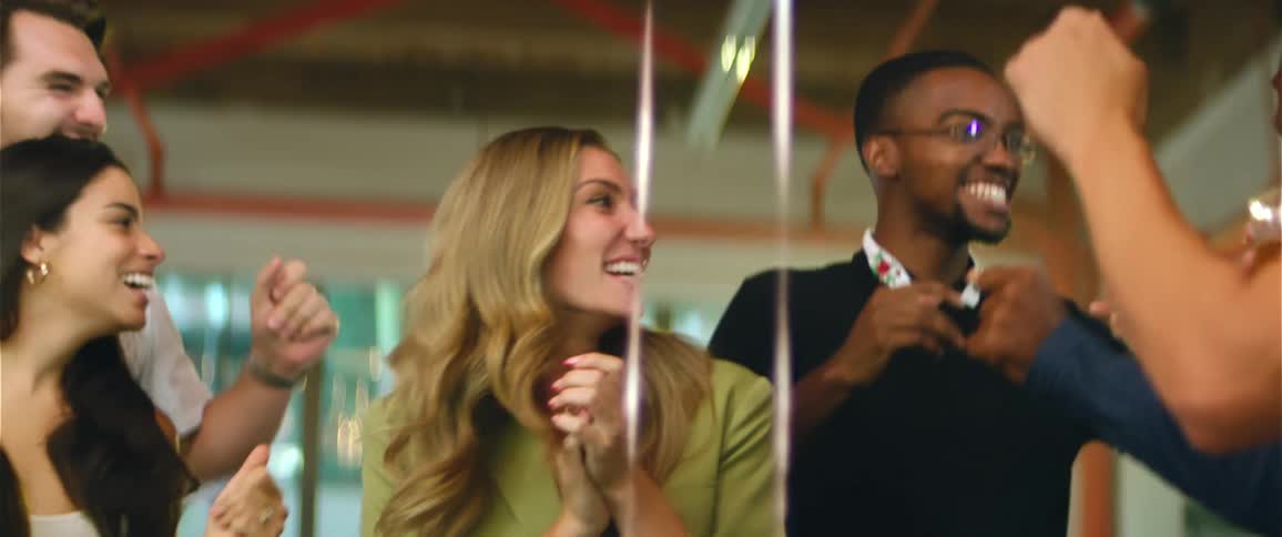 A group of friends laugh and dance at a party