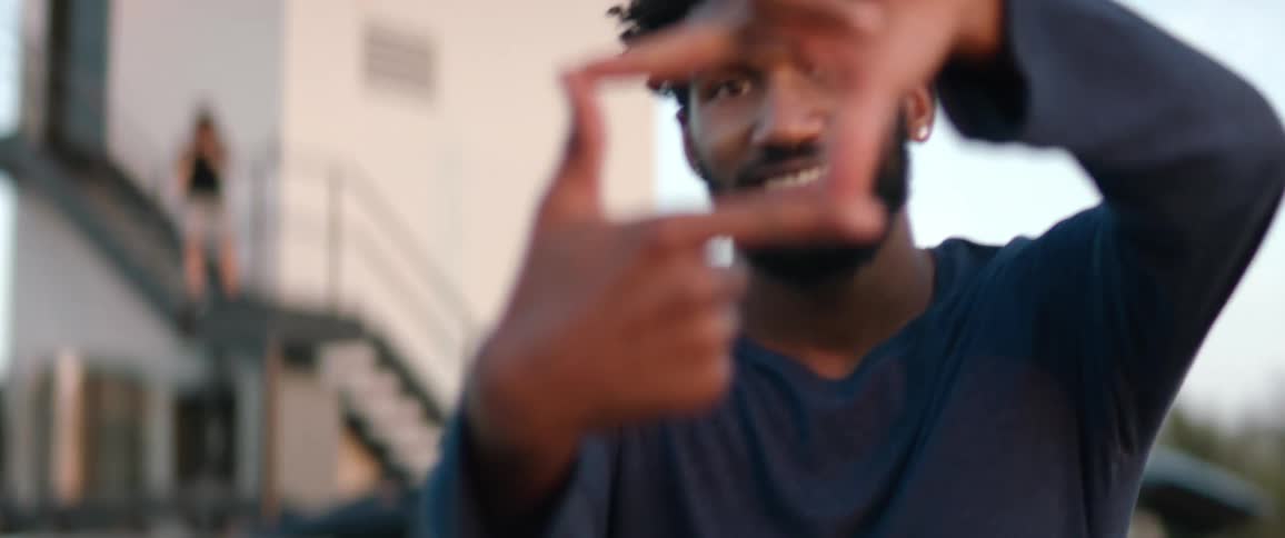 A man gives a hand signal outside