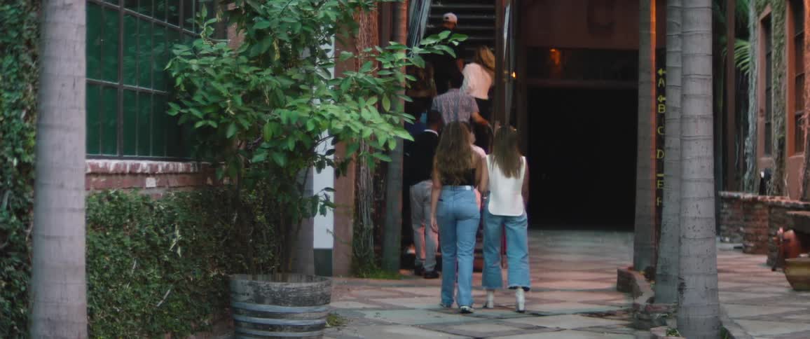 People walk towards the staircase on the building