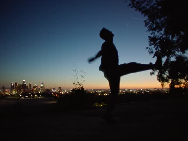 A man is dancing in the dark