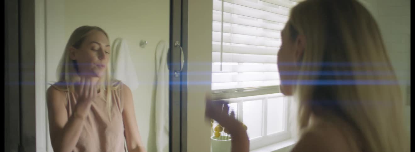 A woman swallows pills in the bathroom
