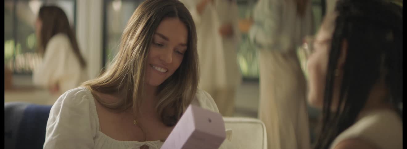 A woman gives her friend a gift