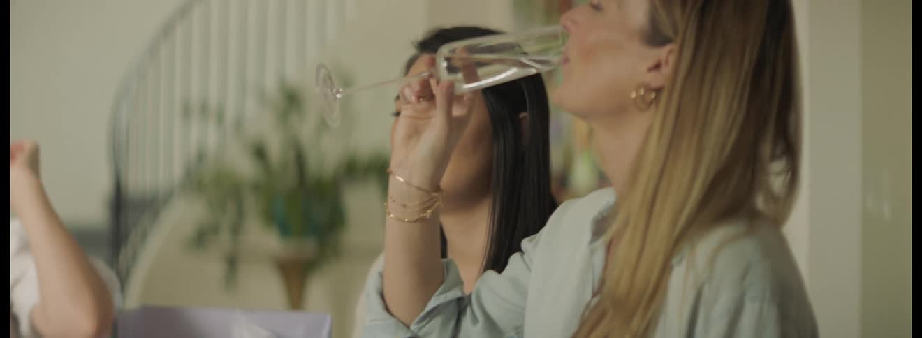 A group of women toast to their pregnant friend at a baby shower