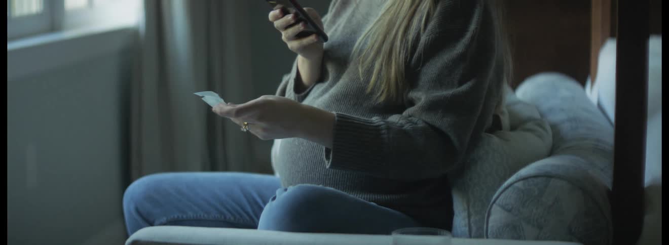 A woman picks up her cell phone