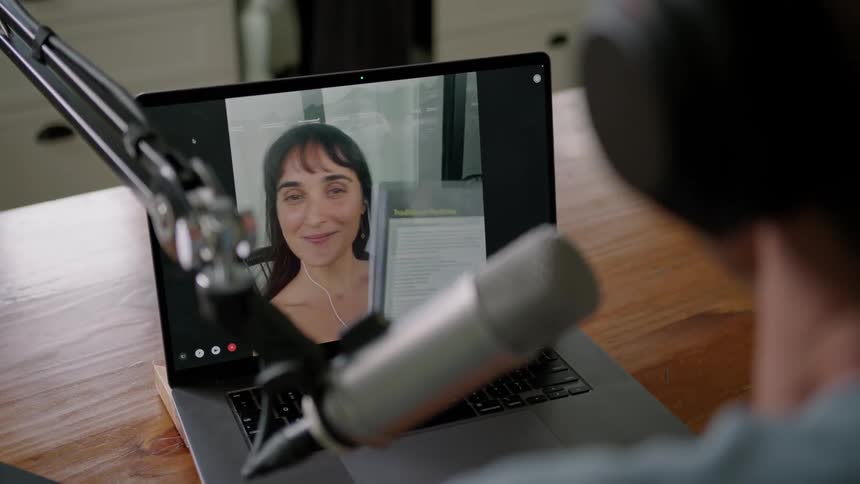 A man and woman talking on a computer
