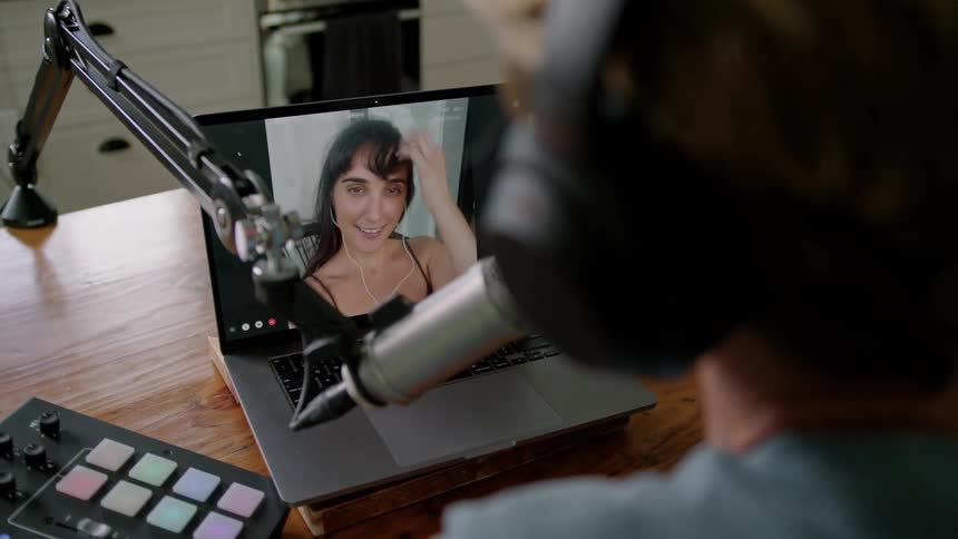 A woman is on laptop talking to someone