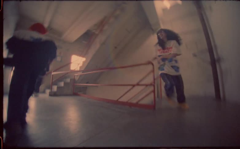 Speed up footage of friends running up a staircase in a building caught on vintage film