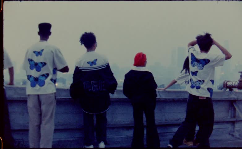 Teenagers stand by the ledge of the roof