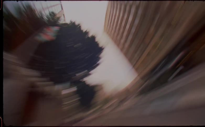 Twisting chaotic footage of the buildings on the city street caught on vintage film