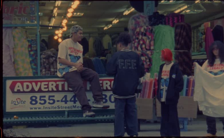 Group of friends hanging out on a bus stop in the city caught on vintage film
