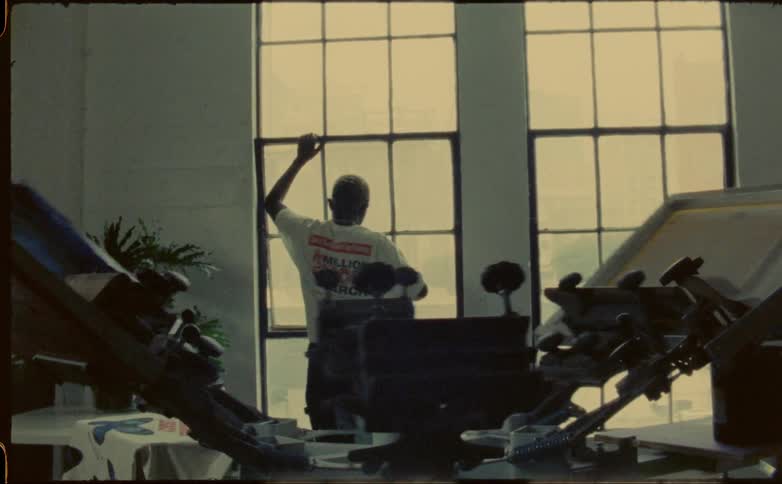 A man walks past the machine to open the window