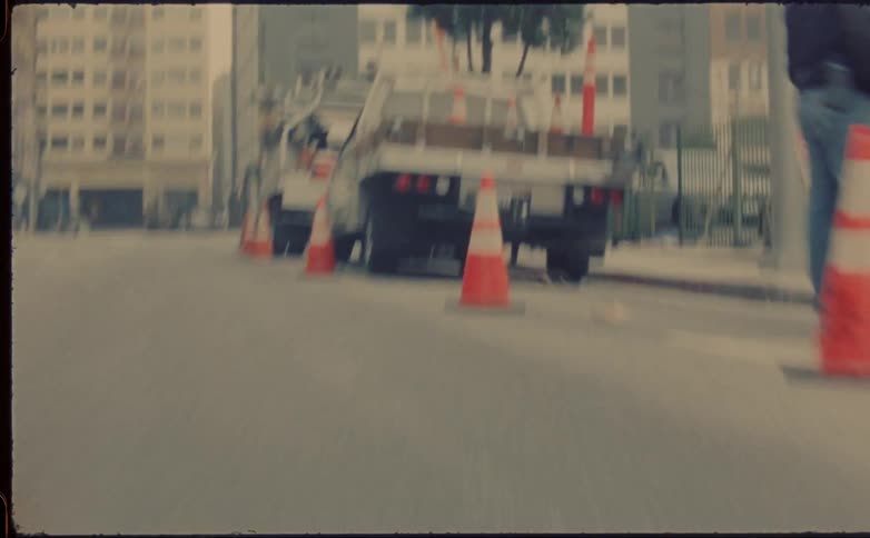 A time lapse of a person skateboarding on a street an the skateboard flies out from under them and goes towards a truck