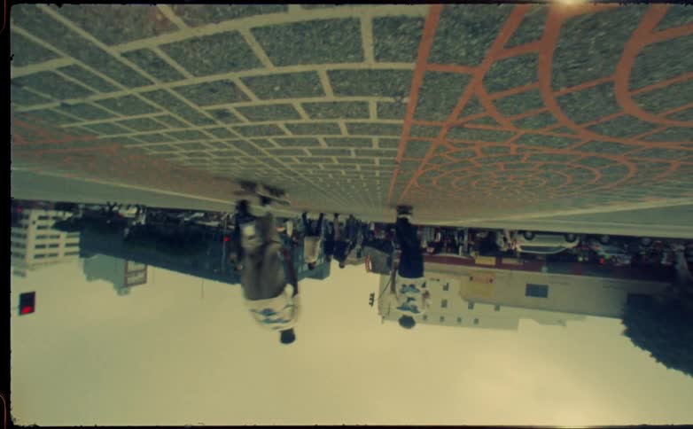 Two young men riding skateboards on the city street at daytime