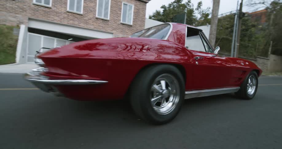 A sports car driving down a road
