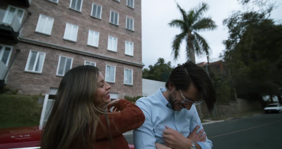 A man and woman are laughing together
