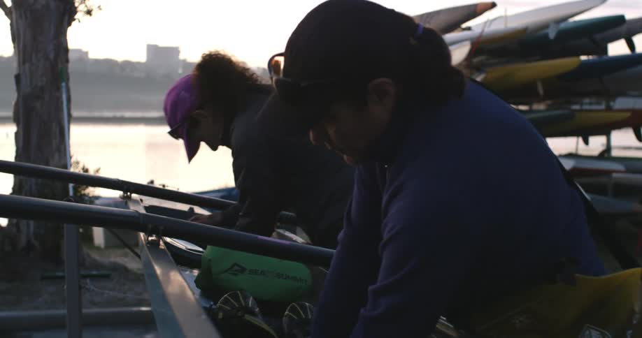 Three woman set up a rowboat