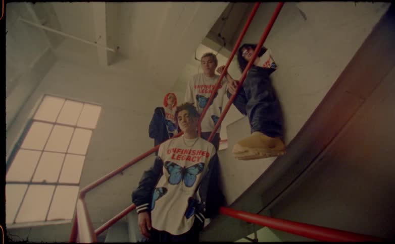 A group of friends sit on the stairwell