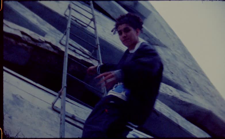 A teenager swings form the ladder