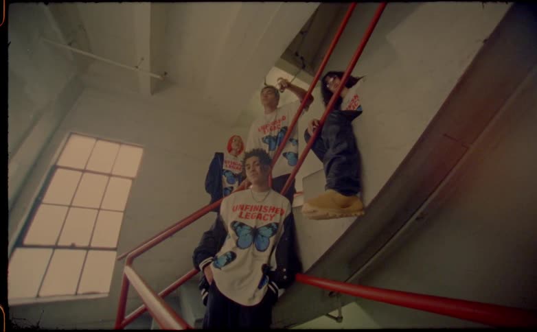 A group of people standing around in a staircase