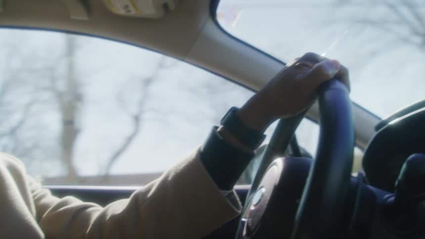 A man driving in his car shakes his head