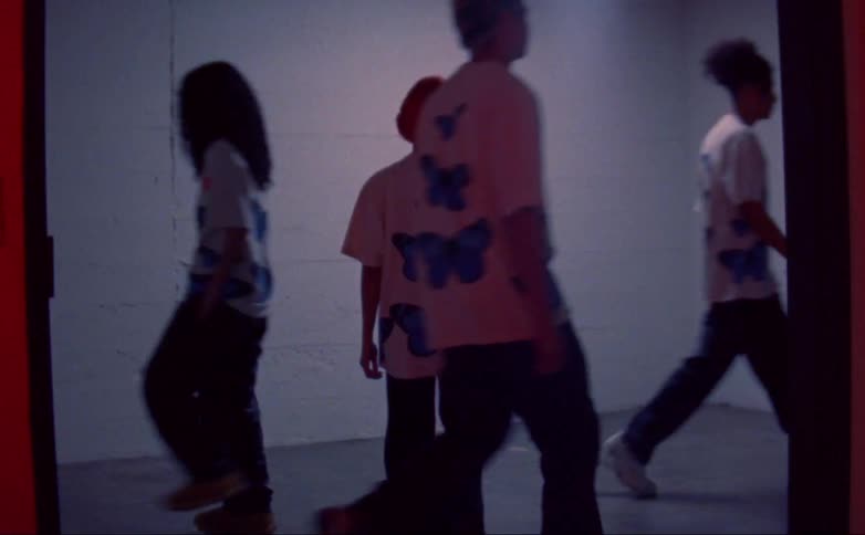 People walk in different directions in the room