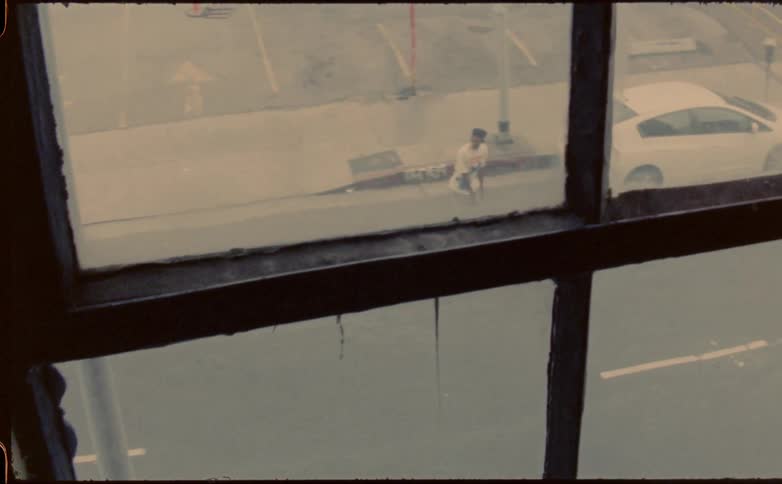A man rides his skateboard down the middle of the street
