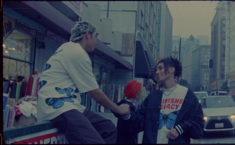 Friends greet each other on the sidewalk