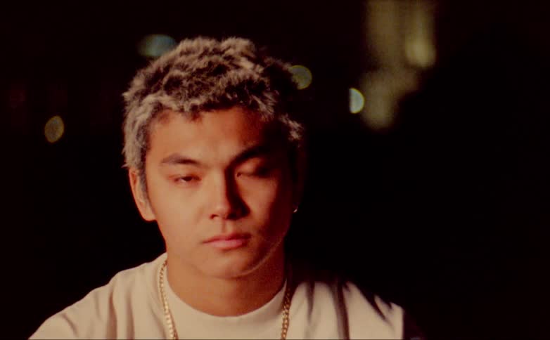 A teenage boy outside at night