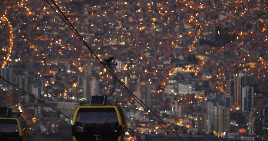 A view of cable cars near a large city