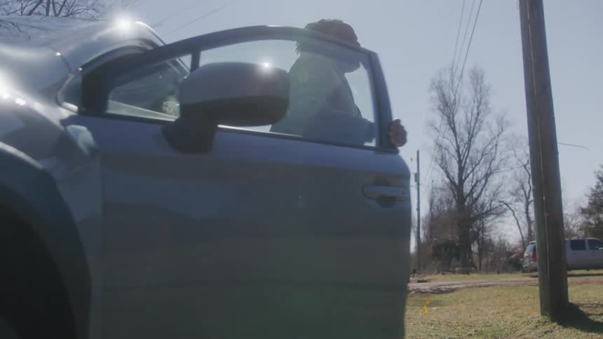 A man gets out of his car