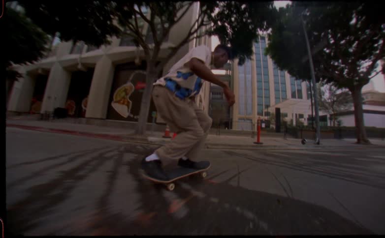 Young man jumping on the city streets with a skateboard caught on vintage film