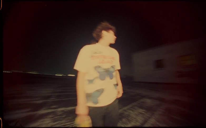 A view of two people standing outdoors with skateboards