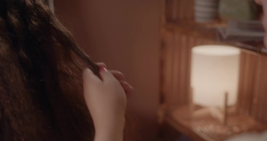 A person is brushing and cutting long hair