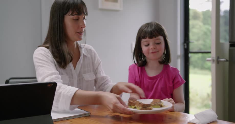 A mother and daughter looking at a tablet