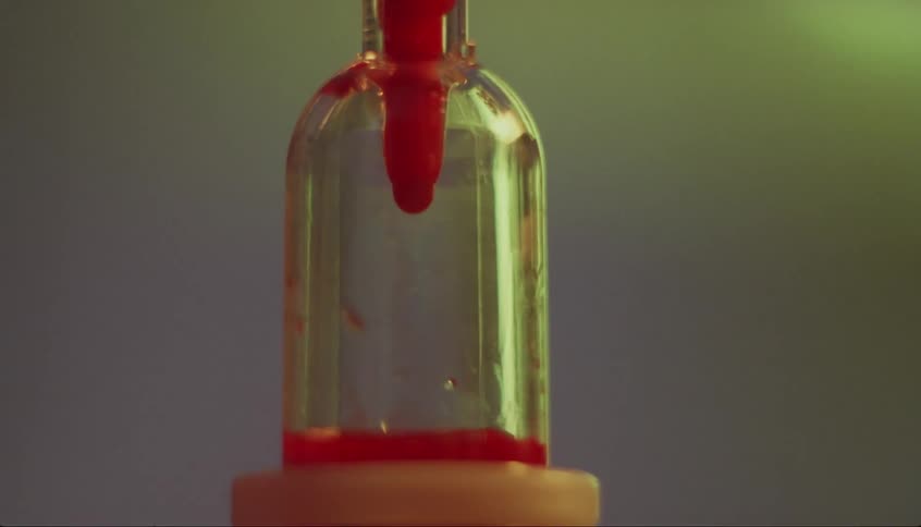 The blood slowly drips into the vial