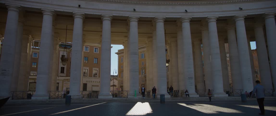 People are walking around the outside of a building