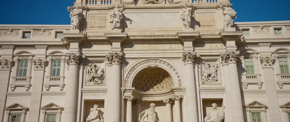 Exterior view of trevi fountain sculptures and papal coat of arms