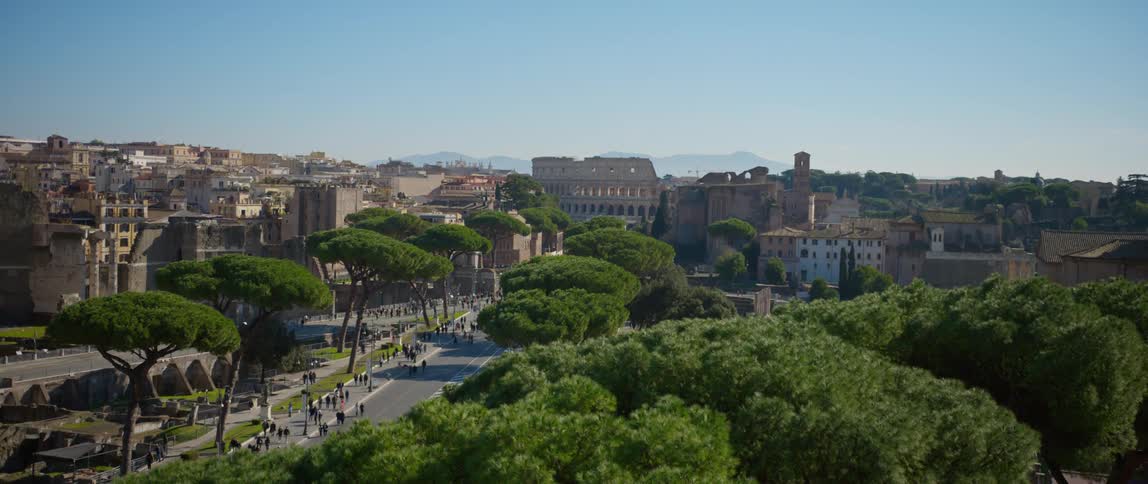 People walk on the street and gather in the park near the colosseum in rome